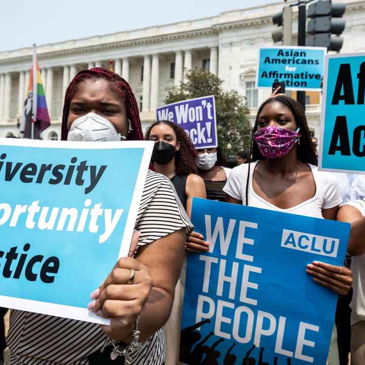 Protesters in front of the Supreme Court hold signs that read, "Diversity, Opportunity, Justice", "ACLU, WE THE PEOPLE", "Affirmative Action YES!" and "Asians for Affirmative Action".